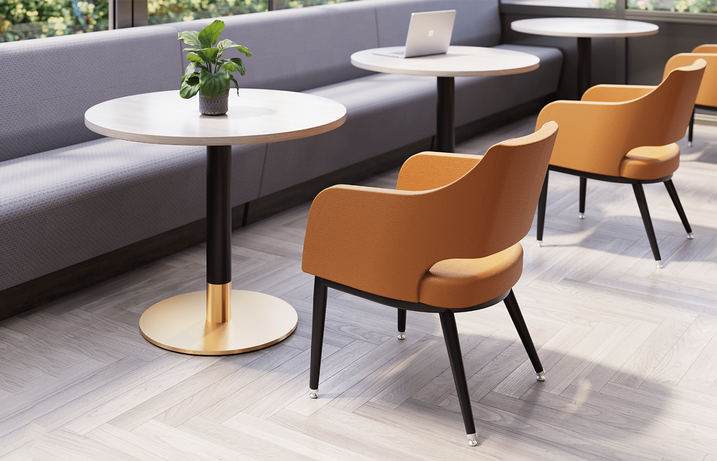 Falcon furniture in a bright lounge setting with orange chairs and round tables