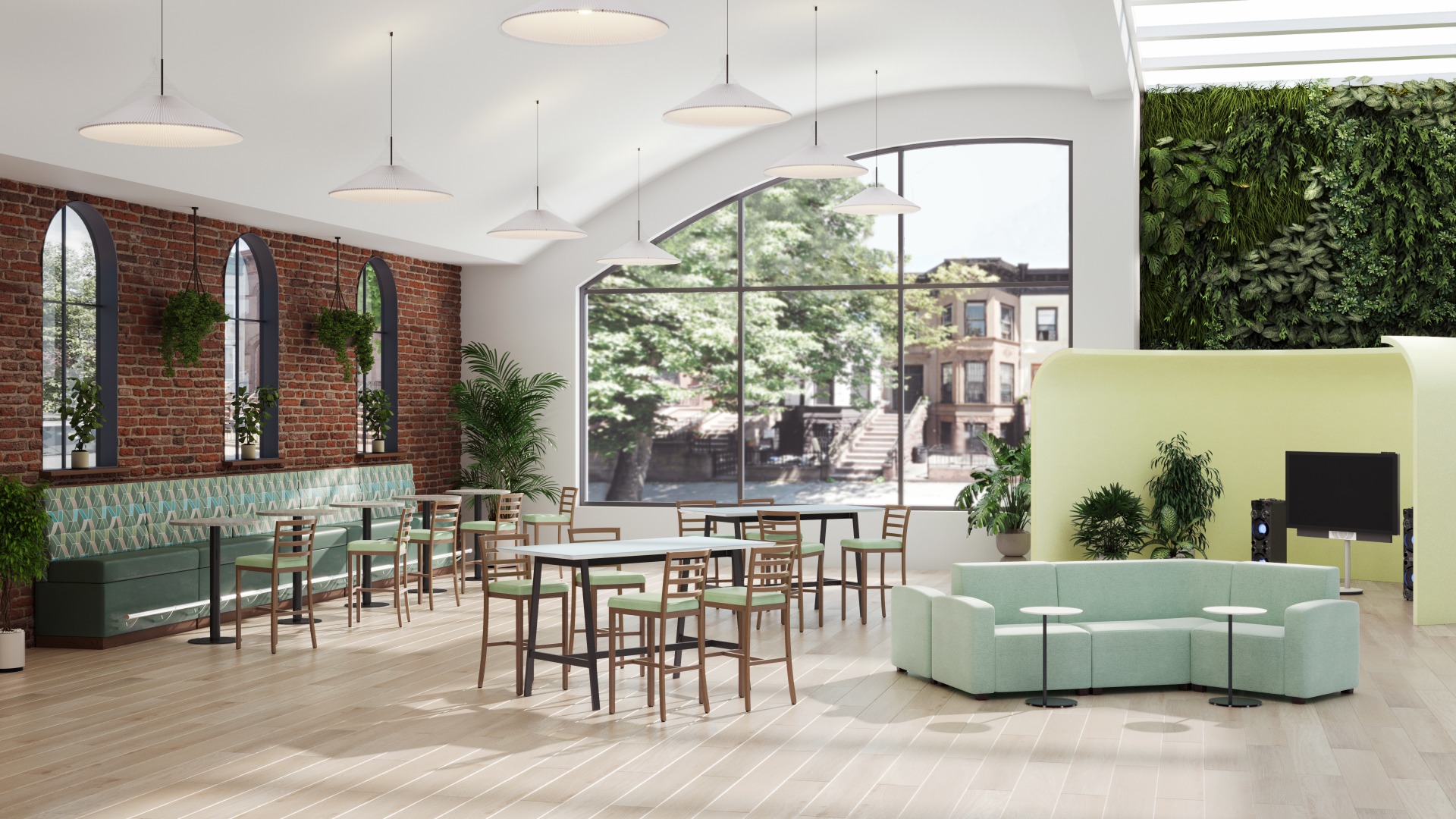 Bright, modern community space with wood and green upholstered furniture, brick walls and a living plant wall